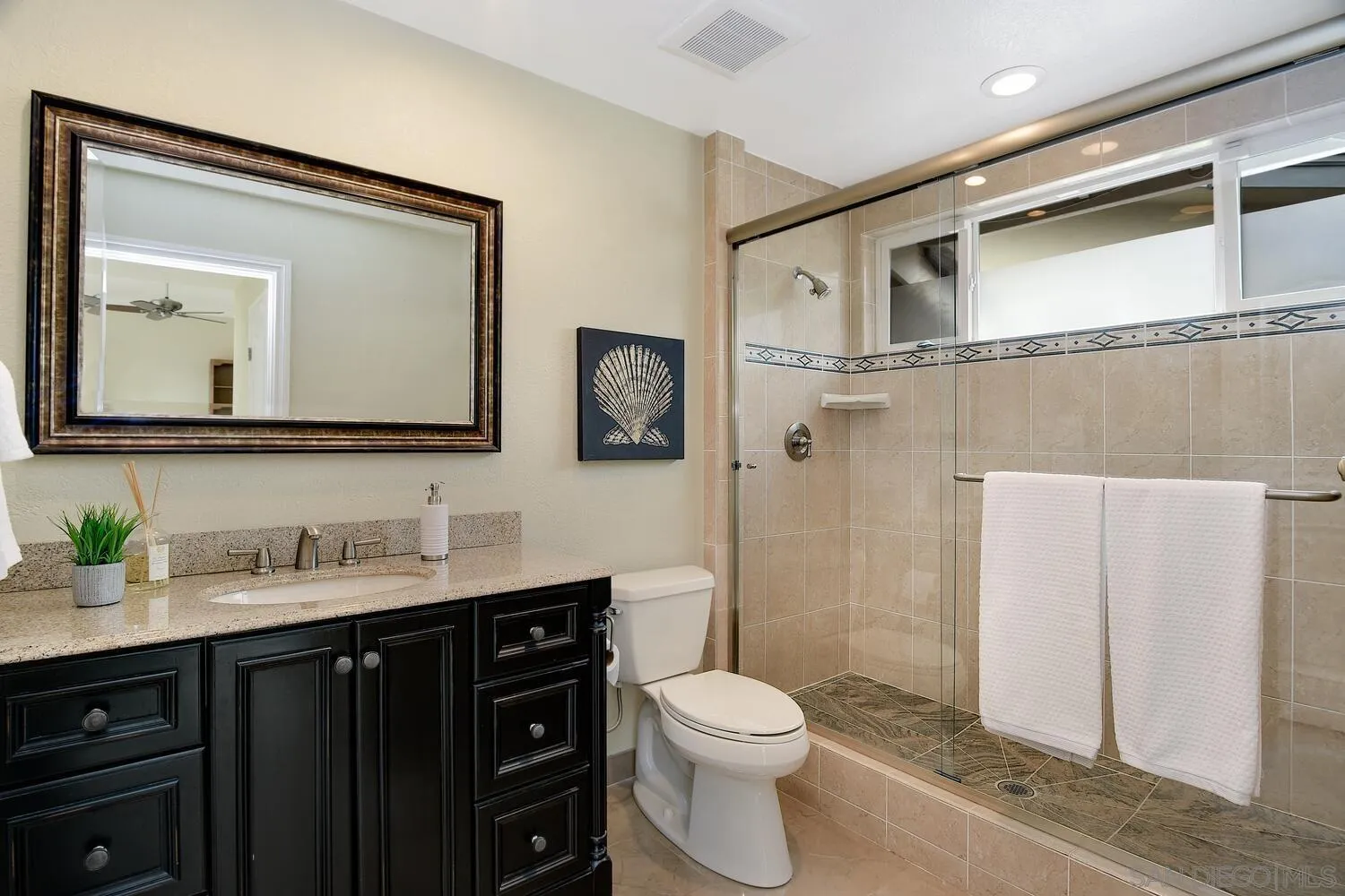5459 Moonlight Lane La Jolla, CA 92037 - Photo 41 of 42 a bathroom with a toilet a sink a mirror a vanity and shower