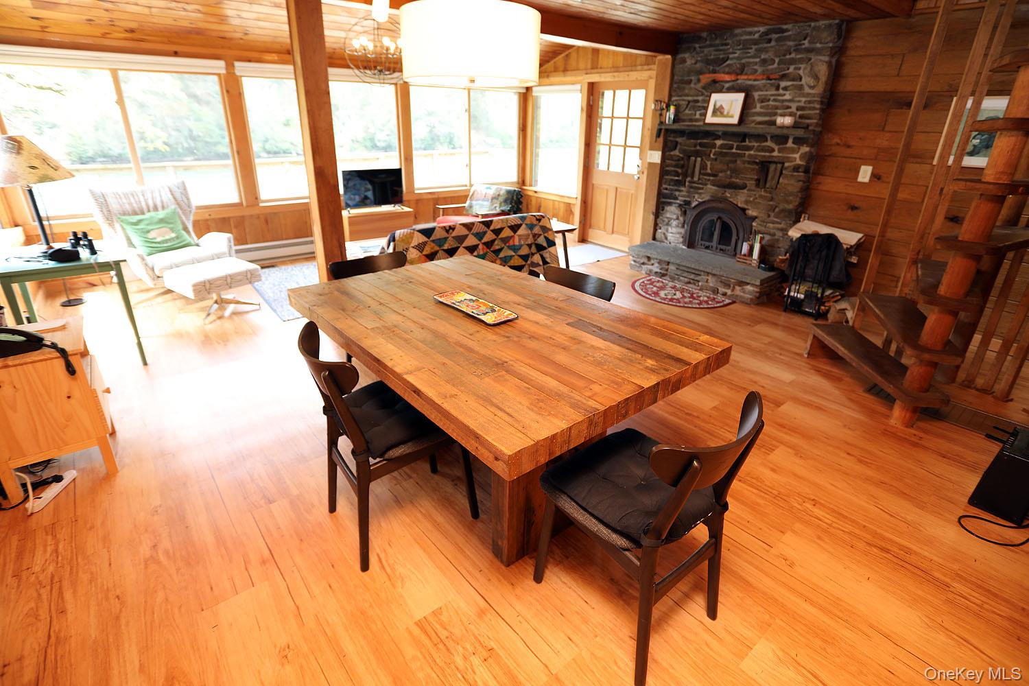 5120 Peas Eddy Road Hancock, NY 13783 - Photo 16 of 37 a living room with a table chairs and a floor to ceiling window
