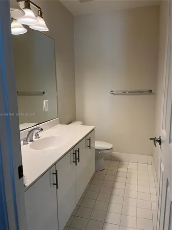 a bathroom with a sink a toilet and mirror