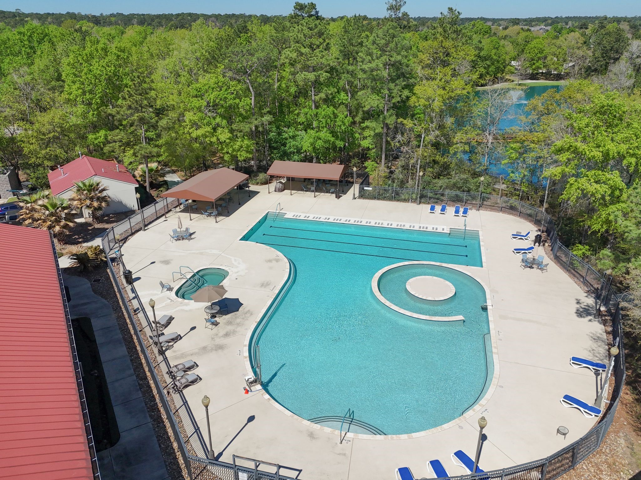 7 Sovereign Way Conroe, TX 77384 - Photo 22 of 31 an aerial view of a swimming pool with outdoor seating and yard in back