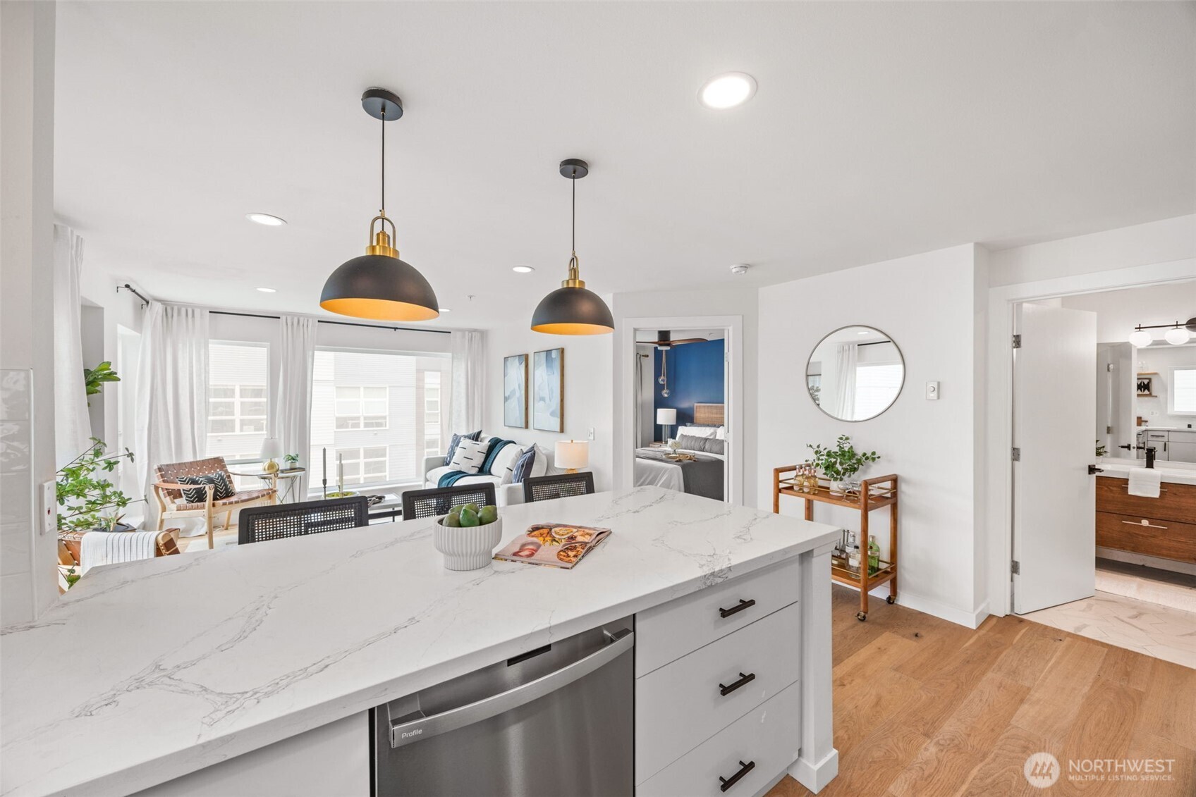 a kitchen with stainless steel appliances granite countertop a sink a stove and a wooden floors