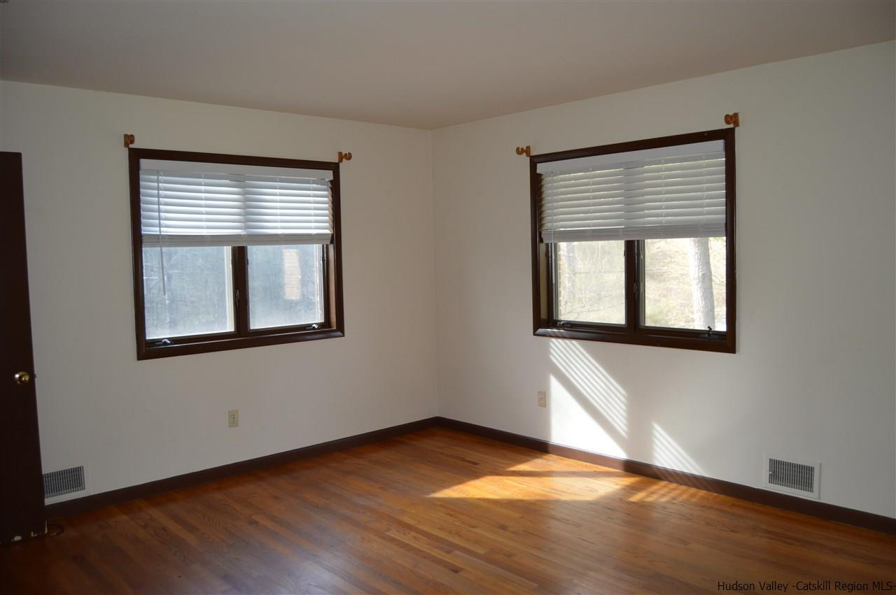 8 Skytop Drive Kingston, NY 12401 - Photo 11 of 23 a view of an empty room with wooden floor and a window