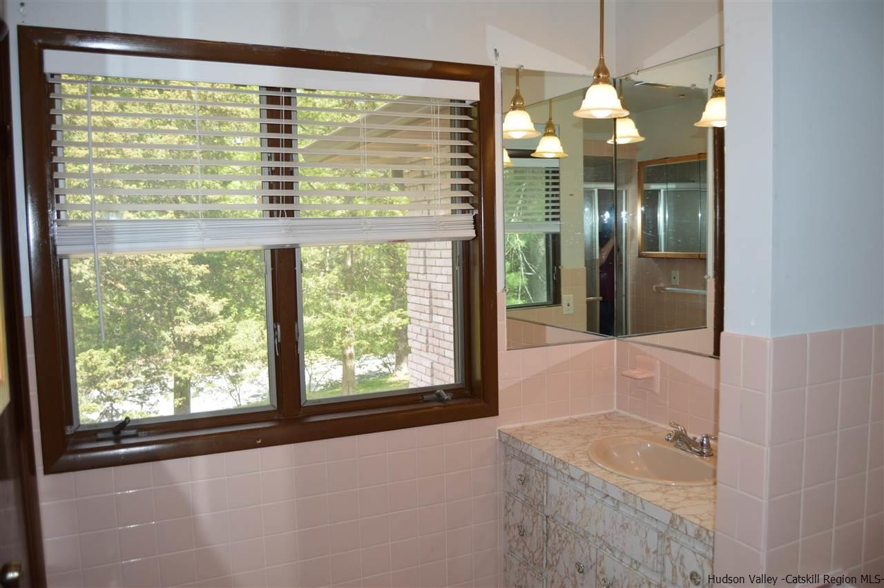 8 Skytop Drive Kingston, NY 12401 - Photo 12 of 23 a bathroom with a granite countertop sink and a large mirror