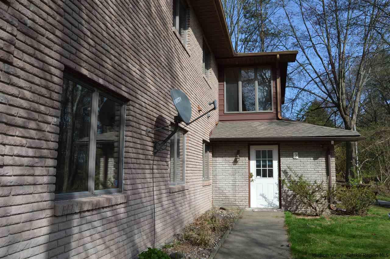 8 Skytop Drive Kingston, NY 12401 - Photo 16 of 23 a view of a white house with large windows and a table and chairs
