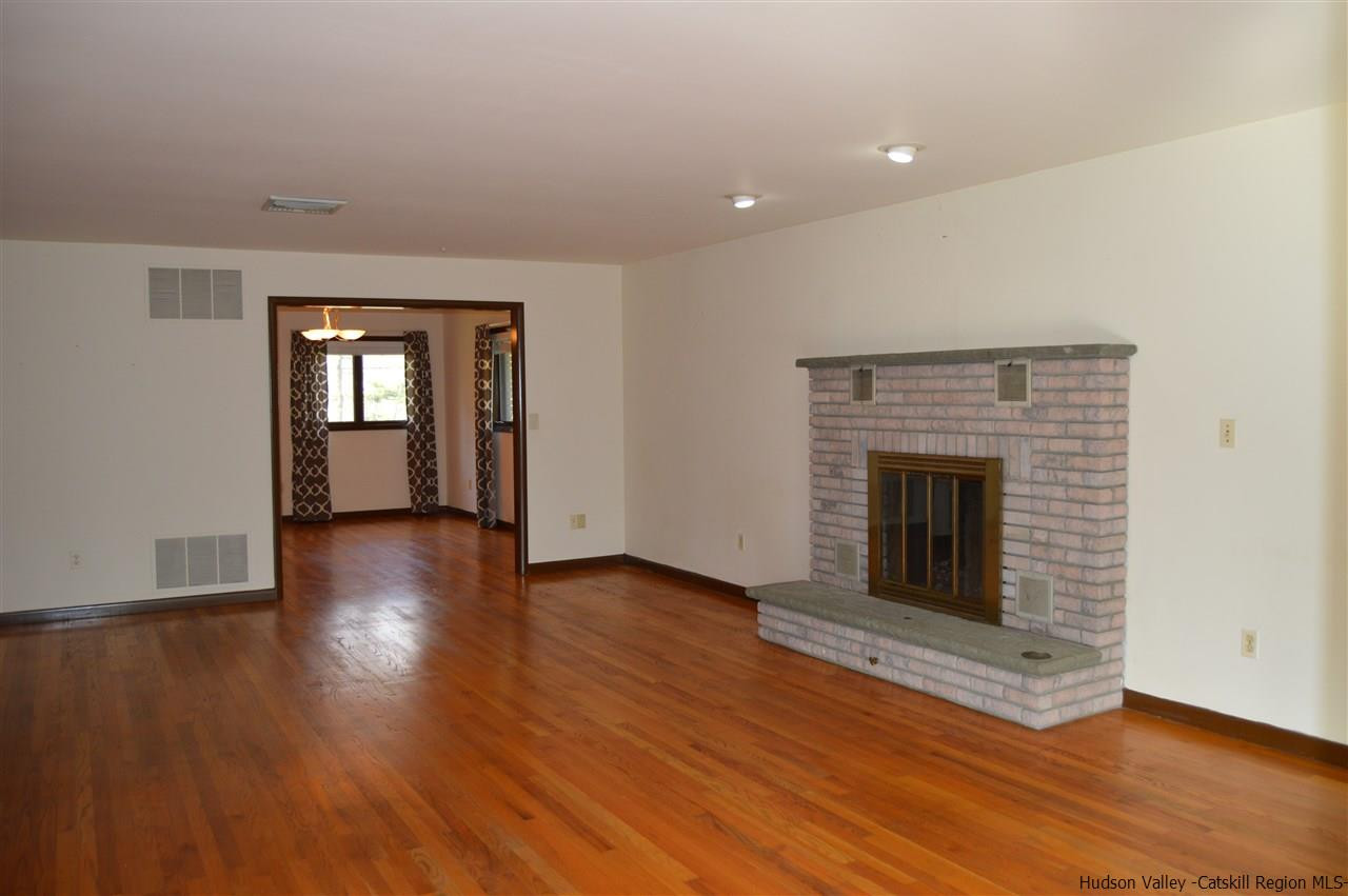 8 Skytop Drive Kingston, NY 12401 - Photo 9 of 23 an empty room with wooden floor and fireplace