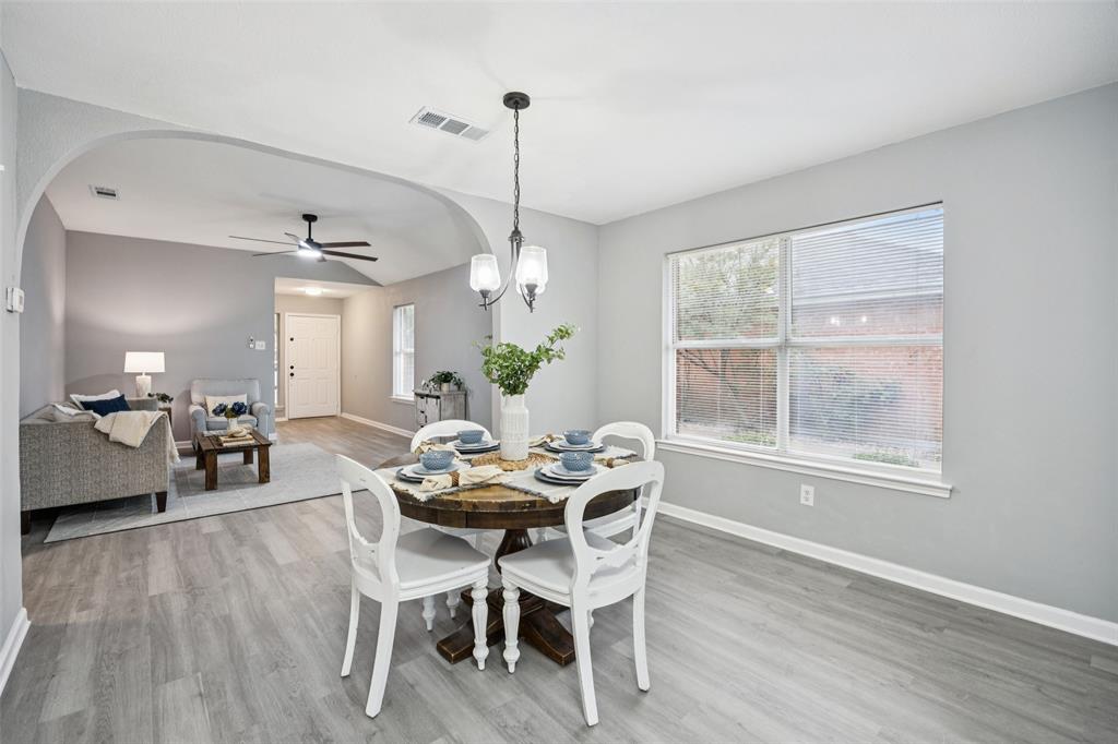621 Renaissance Place Cedar Hill, TX 75104 - Photo 11 of 28 a dining room with furniture a chandelier and wooden floor