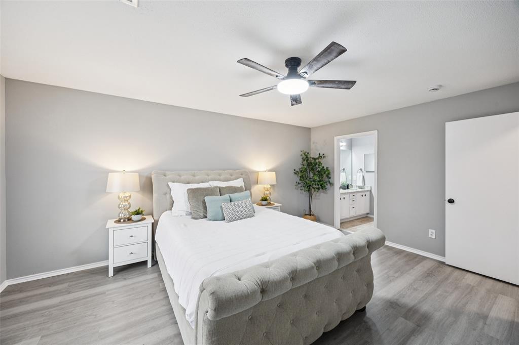 621 Renaissance Place Cedar Hill, TX 75104 - Photo 14 of 28 a bedroom with a large bed and a chandelier