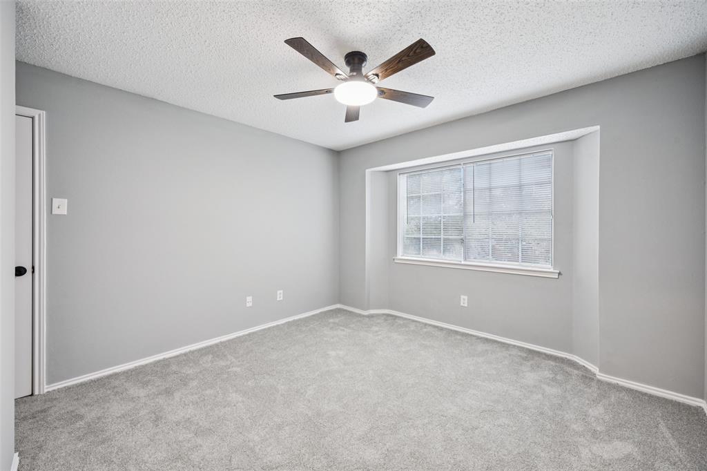 621 Renaissance Place Cedar Hill, TX 75104 - Photo 19 of 28 an empty room with ceiling fan and windows