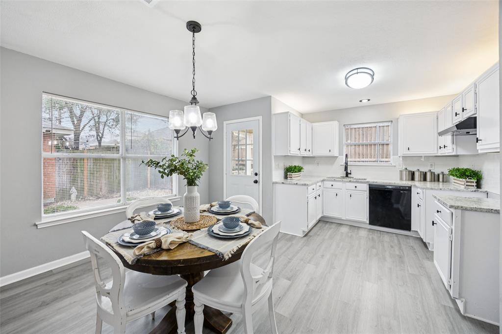 621 Renaissance Place Cedar Hill, TX 75104 - Photo 9 of 28 a kitchen with stainless steel appliances kitchen island granite countertop a stove a sink dishwasher a dining table and chairs with wooden floor