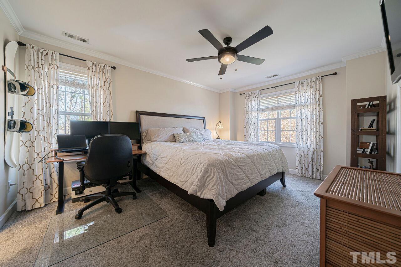4500 Centrebrook Circle Raleigh, NC 27616 - Photo 24 of 39 a bedroom with a bed and a chandelier