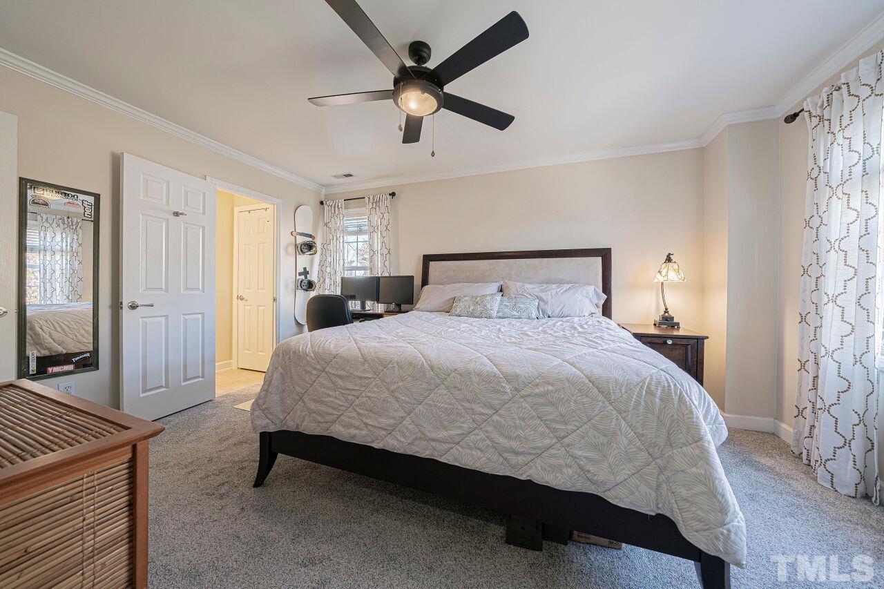 4500 Centrebrook Circle Raleigh, NC 27616 - Photo 25 of 39 a spacious bedroom with a bed and a ceiling fan