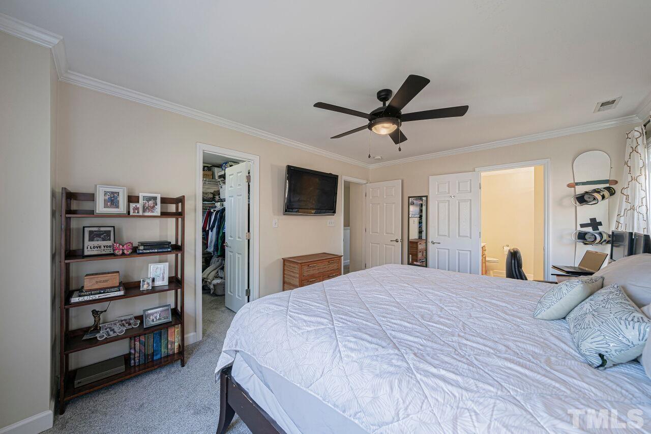 4500 Centrebrook Circle Raleigh, NC 27616 - Photo 26 of 39 a bedroom with a large bed and a tv