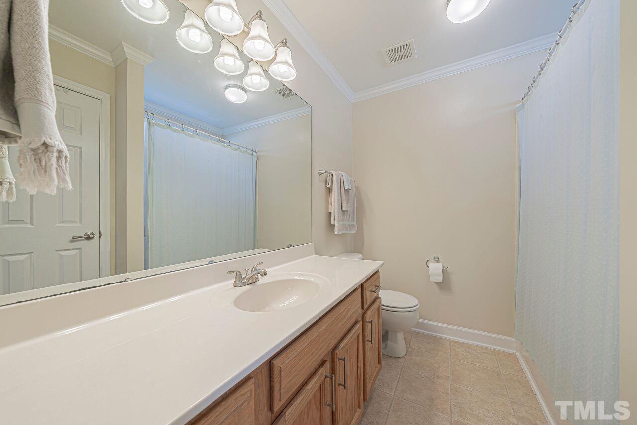 4500 Centrebrook Circle Raleigh, NC 27616 - Photo 28 of 39 a bathroom with a sink a toilet and a mirror