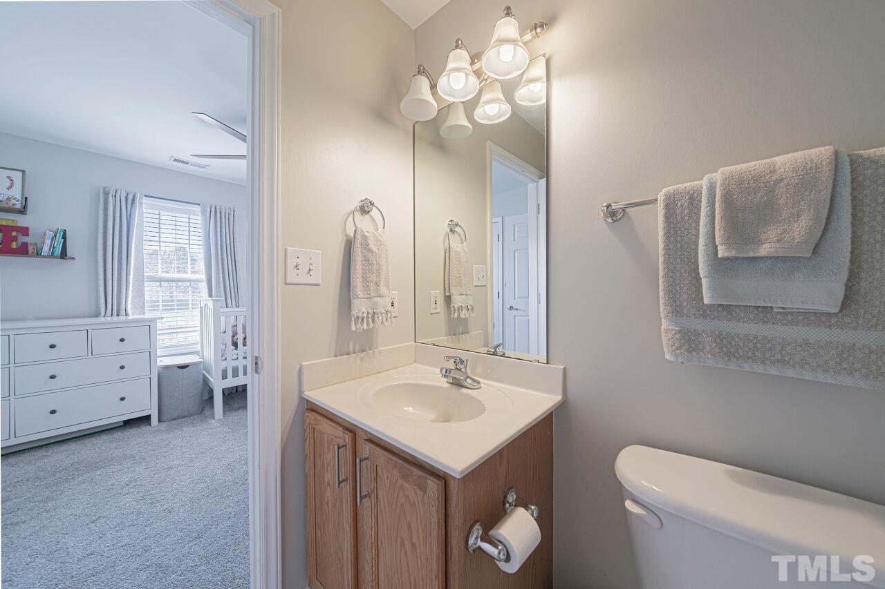 4500 Centrebrook Circle Raleigh, NC 27616 - Photo 34 of 39 a bathroom with a toilet sink and mirror
