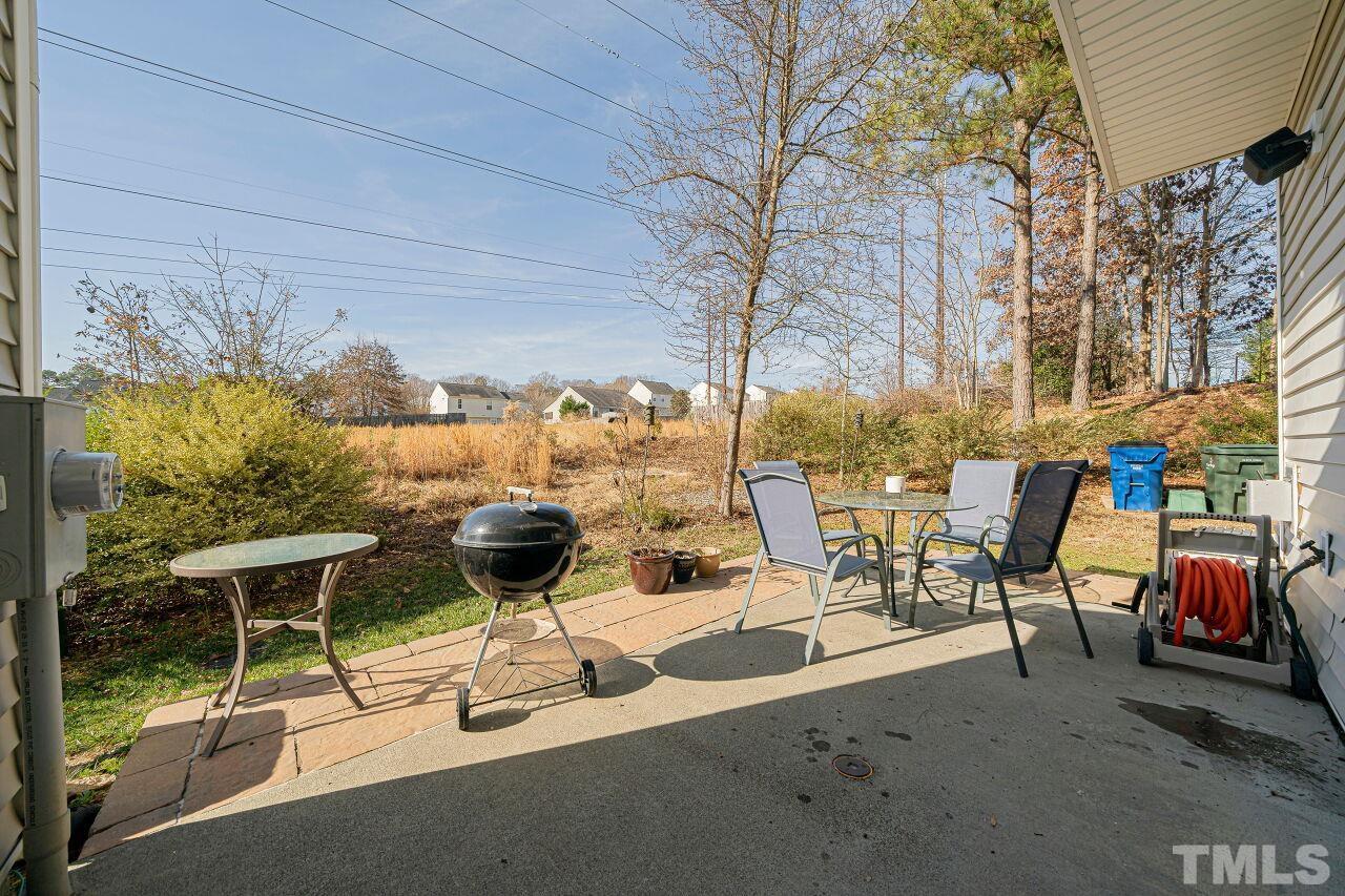 4500 Centrebrook Circle Raleigh, NC 27616 - Photo 35 of 39 a view of a patio with a table and chairs and potted plants