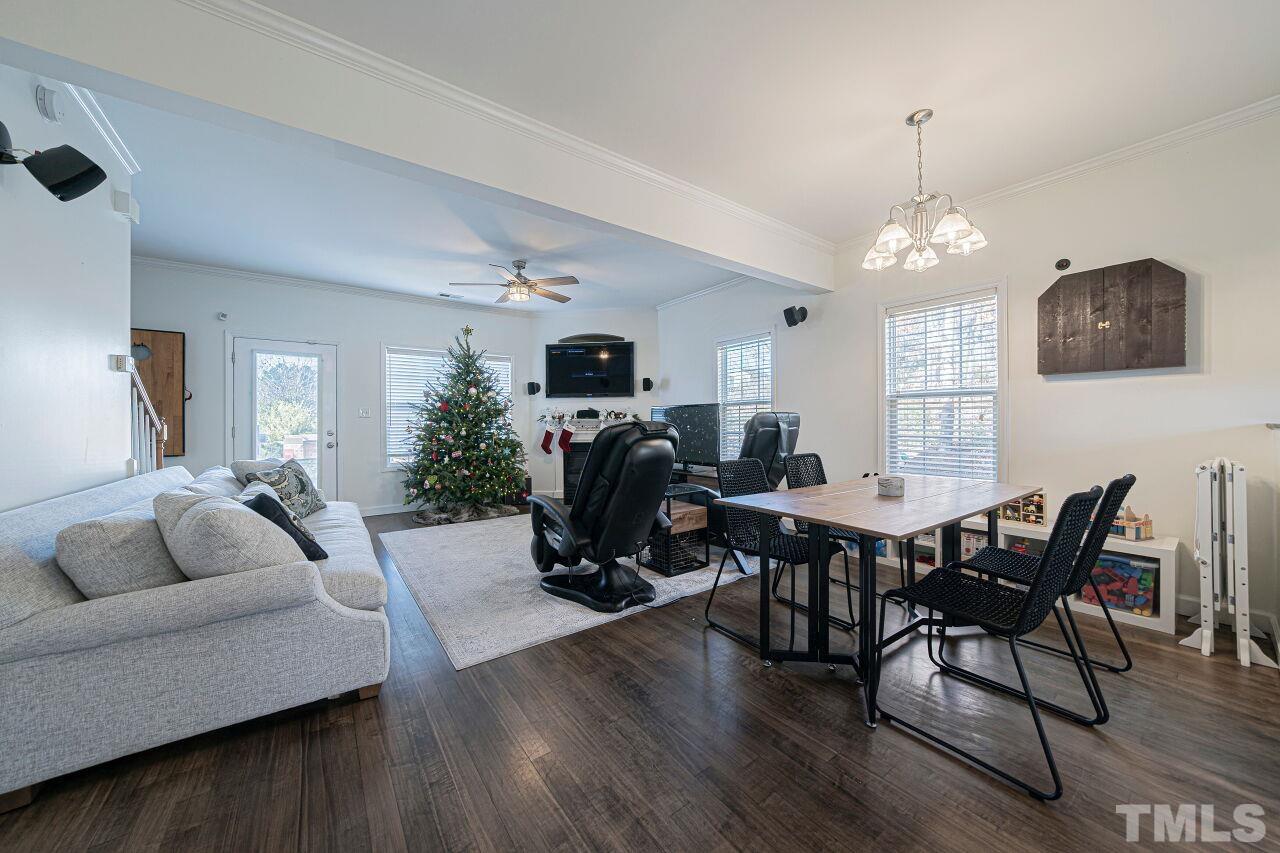 4500 Centrebrook Circle Raleigh, NC 27616 - Photo 6 of 39 a living room with furniture a dining table and a chandelier