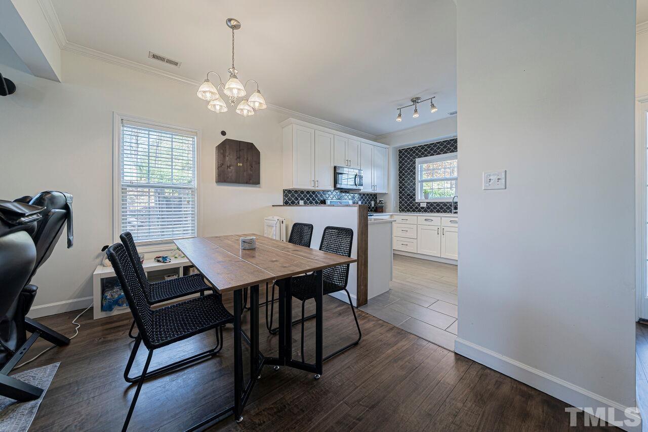 4500 Centrebrook Circle Raleigh, NC 27616 - Photo 7 of 39 a view of a dining room with furniture and a chandelier