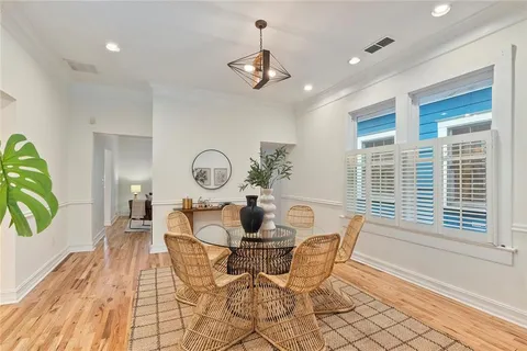 a view of a dining room with furniture window and wooden floor