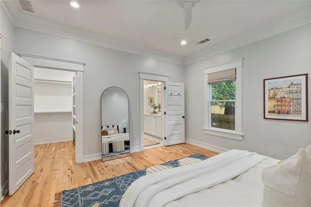 a bedroom with a bed and a large window