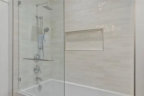 a bathroom with a shower and a bath tub
