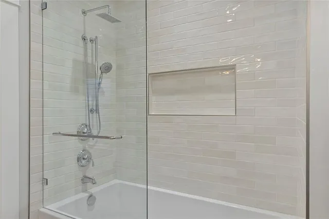 a bathroom with a shower and a bath tub