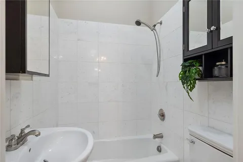 a bathroom with a shower and a sink