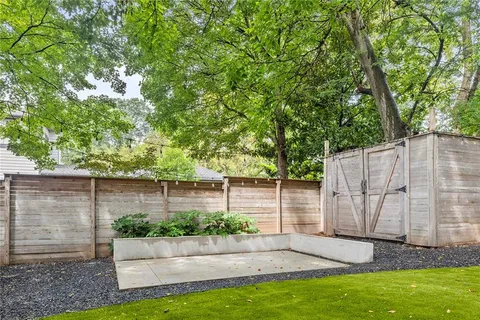 a view of a backyard with a garden and entertaining space
