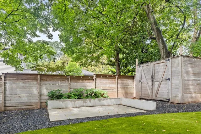 a view of a backyard with a garden and entertaining space