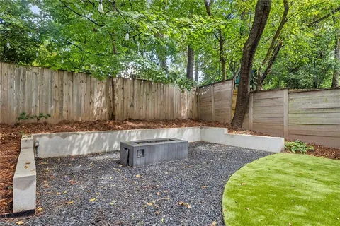 a view of a backyard with a small cabin and a chair