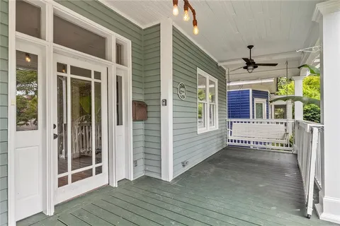 a view of a porch with wooden floor and a ceiling fan