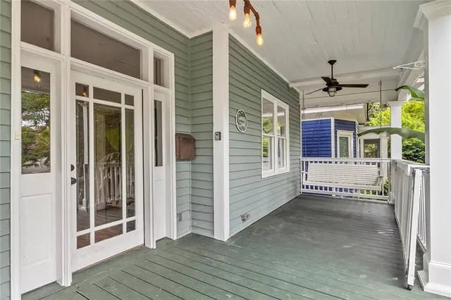 a view of a porch with wooden floor and a ceiling fan