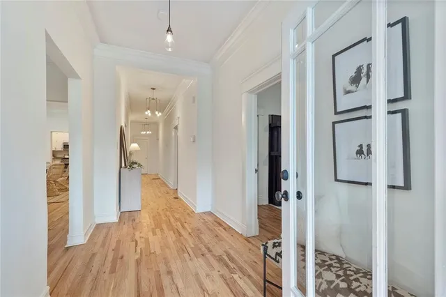 a view of a hallway with wooden floor and staircase