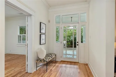 a view of a room with wooden floor and windows