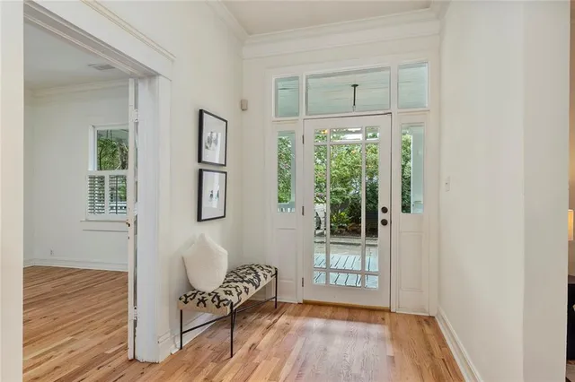 a view of a room with wooden floor and windows
