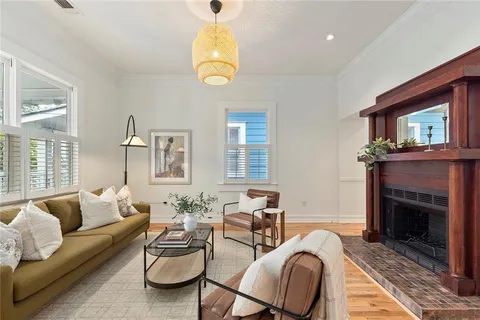 a living room with furniture chandelier and a fireplace