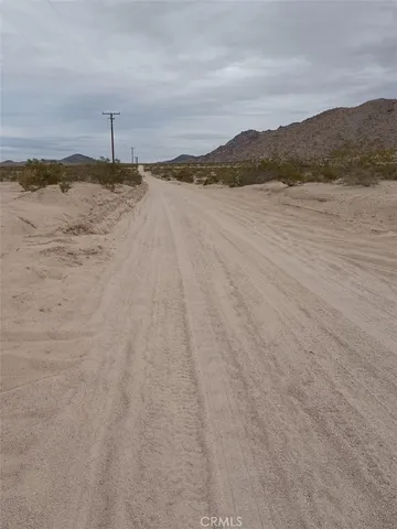 a view of an ocean beach and mountain