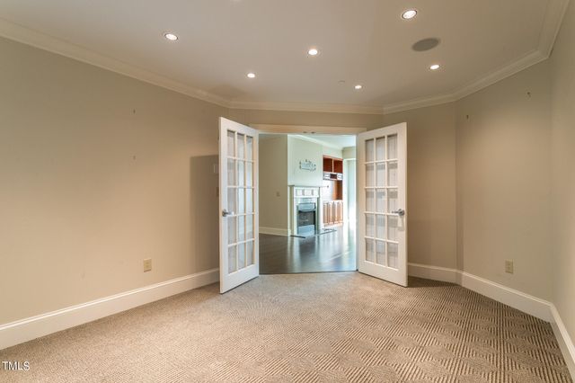 a view of an empty room with furniture and a window