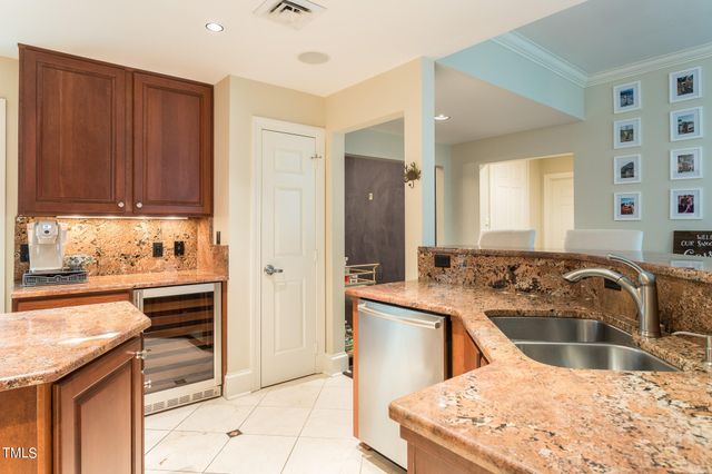a kitchen with stainless steel appliances kitchen island granite countertop a sink stove and refrigerator