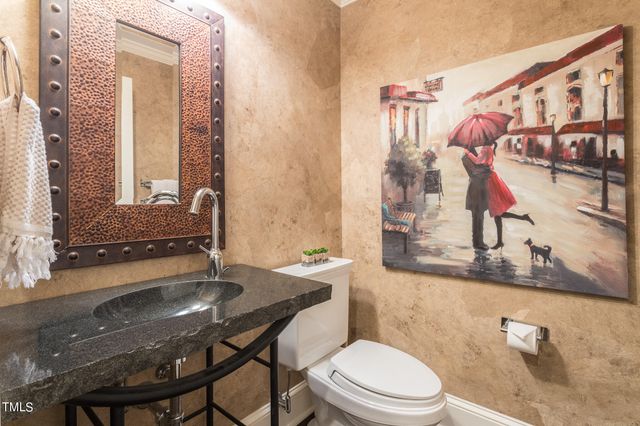 a bathroom with a sink a toilet and mirror