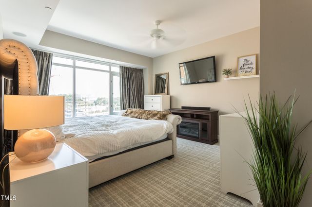 a bedroom with a bed and flat screen tv