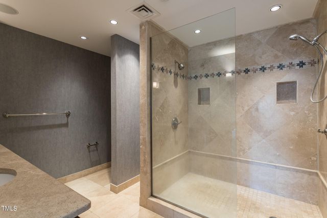 a bathroom with a glass shower door