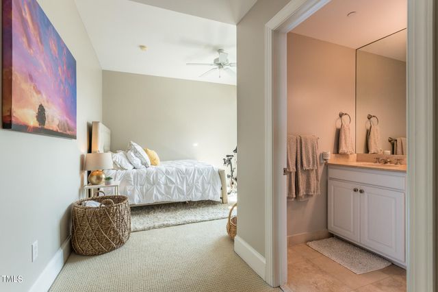 a bedroom with a bed and a mirror