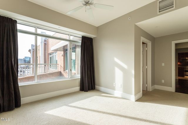 a view of room with window and a ceiling fan
