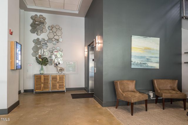 a view of a room with wooden floor and windows