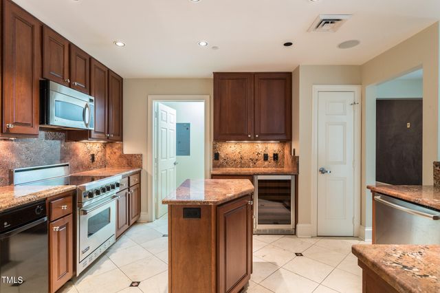 a kitchen with granite countertop a stove and cabinets