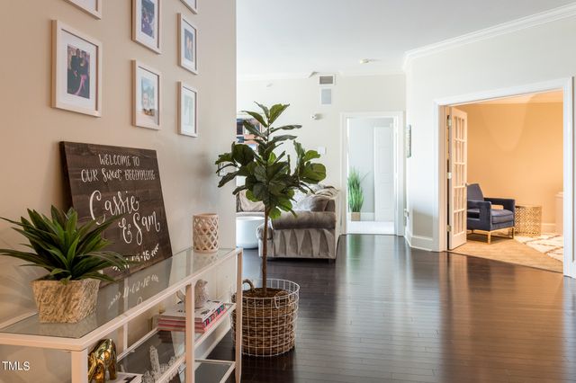 a view of living room filled with furniture bookshelf and a potted plant