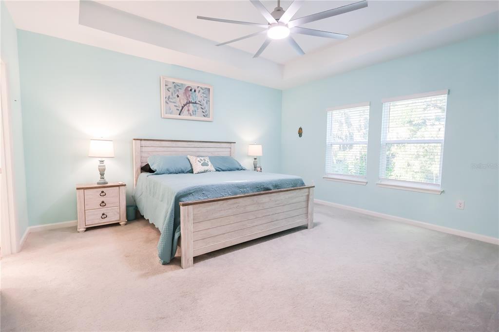 19511 Southwest 77th Loop Dunnellon, FL 34432 - Photo 11 of 27 a bed room with a bed and a chandelier