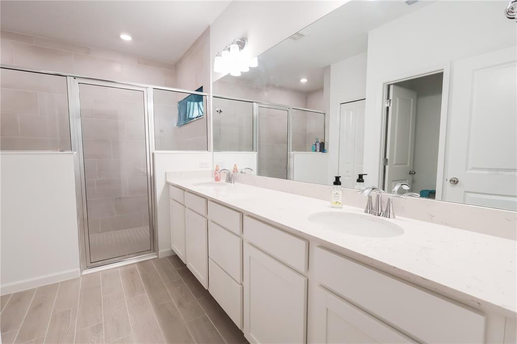 19511 Southwest 77th Loop Dunnellon, FL 34432 - Photo 12 of 27 a bathroom with a double vanity sink mirror and shower