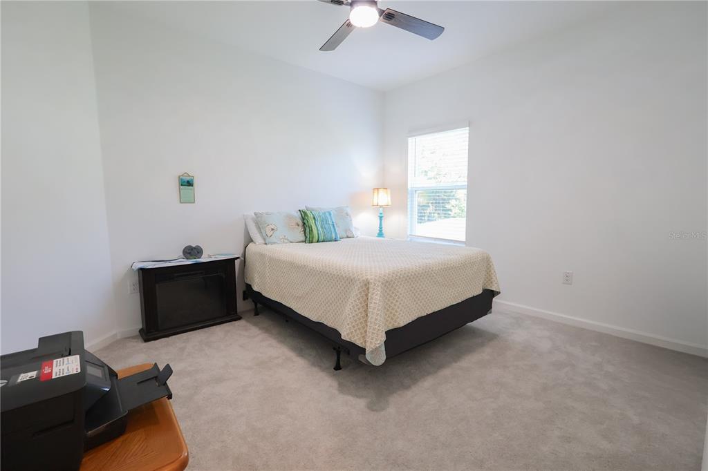 19511 Southwest 77th Loop Dunnellon, FL 34432 - Photo 17 of 27 a bed sitting in a bedroom next to a window