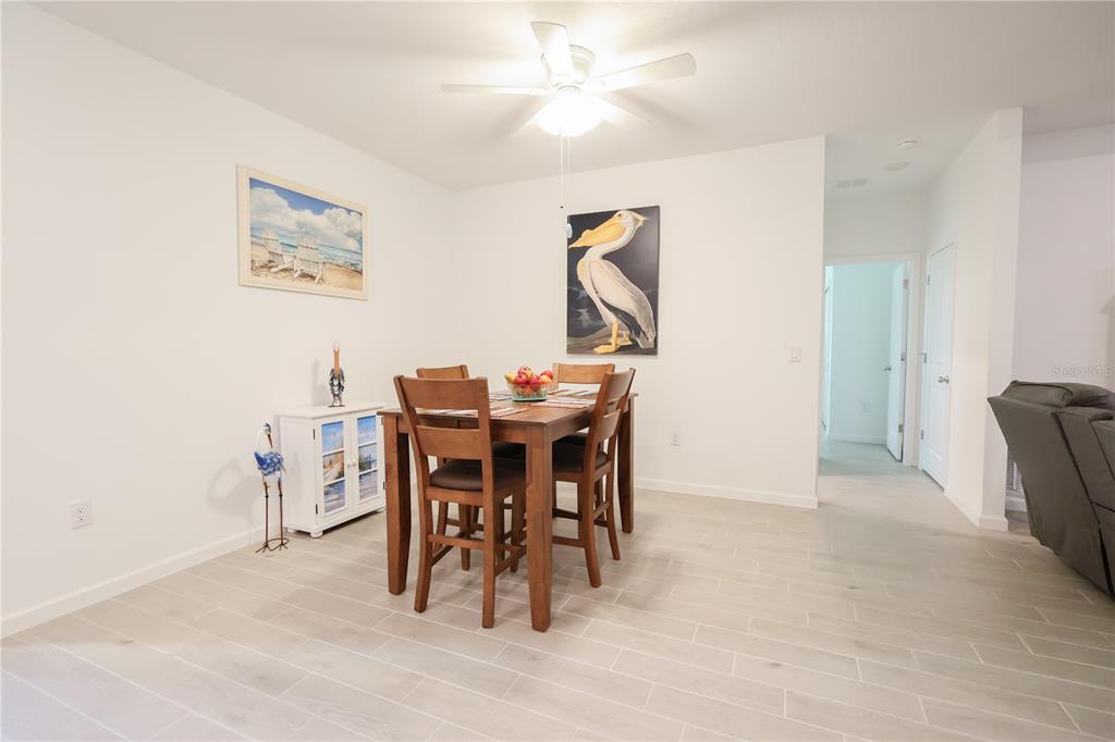 19511 Southwest 77th Loop Dunnellon, FL 34432 - Photo 5 of 27 a dining room with furniture and a painting on the wall